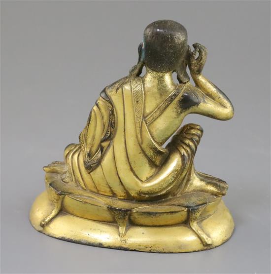 A Sino-Tibetan gilt bronze seated figure of Milarepa, H. 14cm